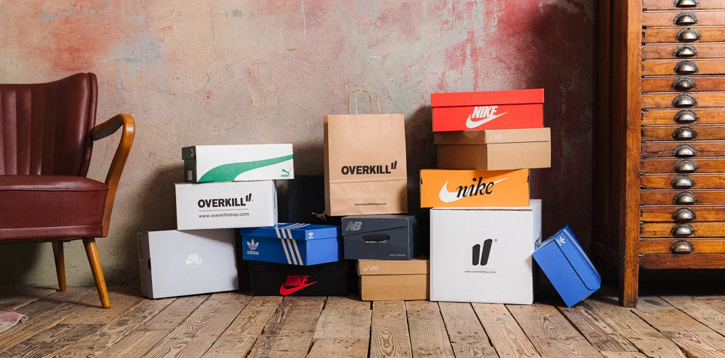 sneaker boxes from different brands like adidas & nike promoting the sale category